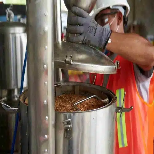 Close-up of palo santo oil extraction during in-origin processing in Peru, showing the production stage behind natural palo santo derivatives.