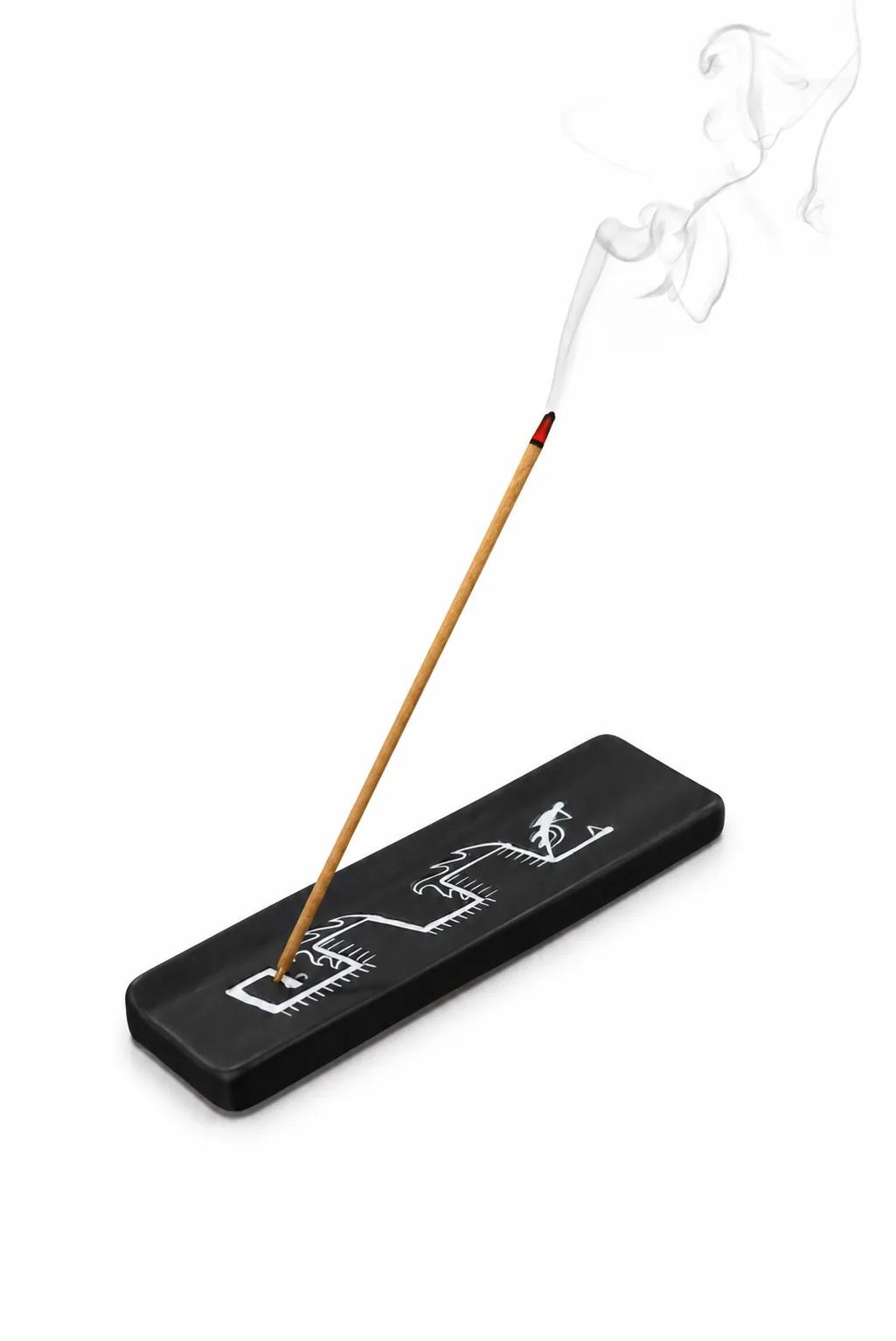 Munay Serpent black ceramic incense stick holder with a lit incense stick, handmade in Peru