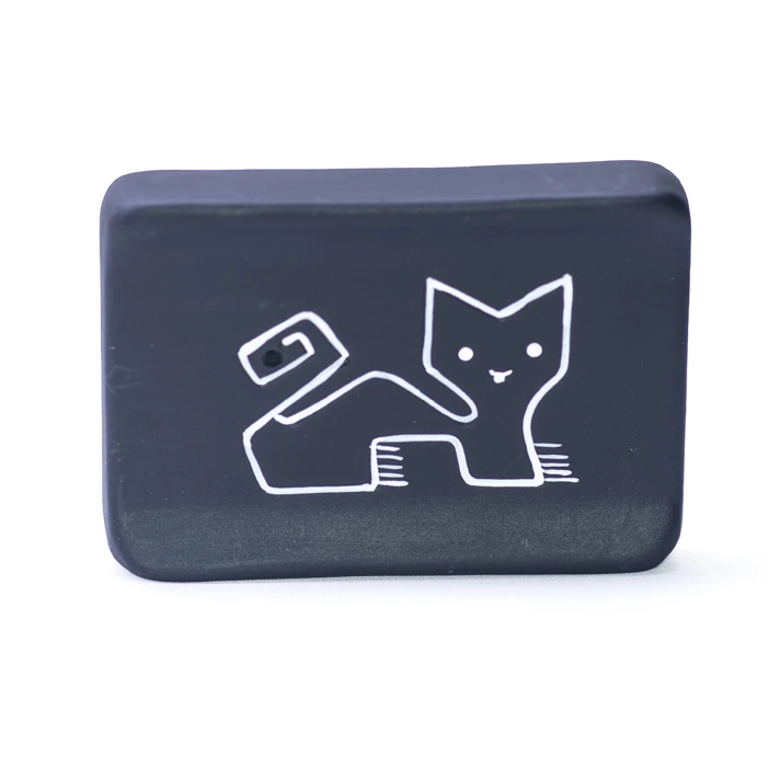 Solid palo santo stick resting on handmade ceramic Puma holder with Andean design