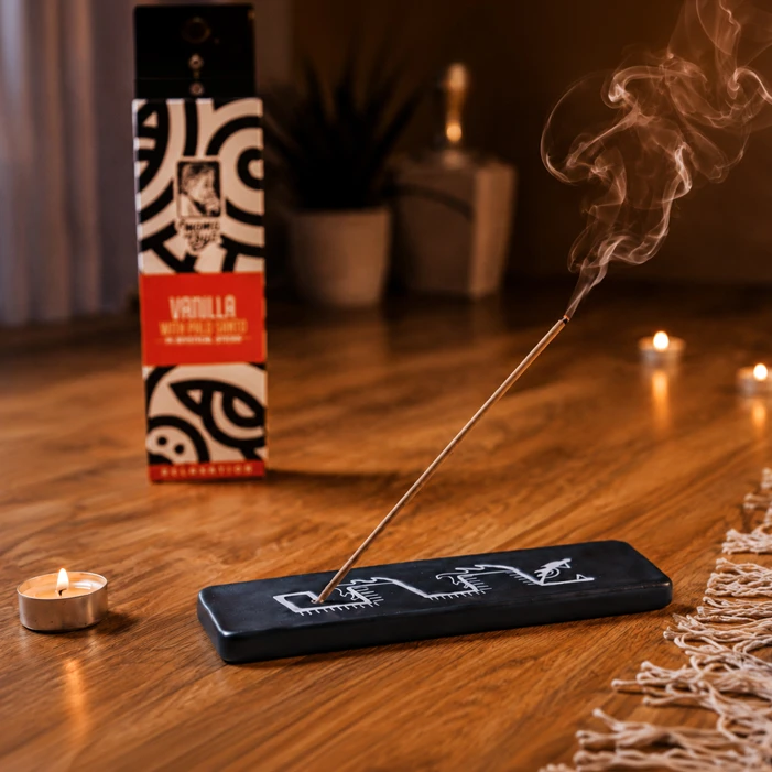 Vanilla with Palo Santo incense stick burning in a warm candlelit ambience